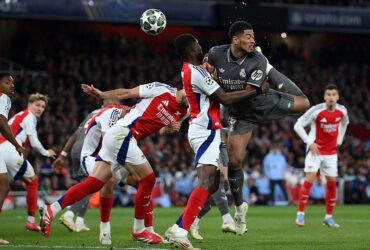 LONDON, ENGLAND - APRIL 08: Jude Bellingham of Real Madrid shoots at goal whilst under pressure from Thomas Partey of Arsenal during the UEFA Champions League 2024/25 Quarter Final First Leg match between Arsenal FC and Real Madrid C.F. at Emirates Stadium on April 08, 2025 in London, England. (Photo by Justin Setterfield/Getty Images)